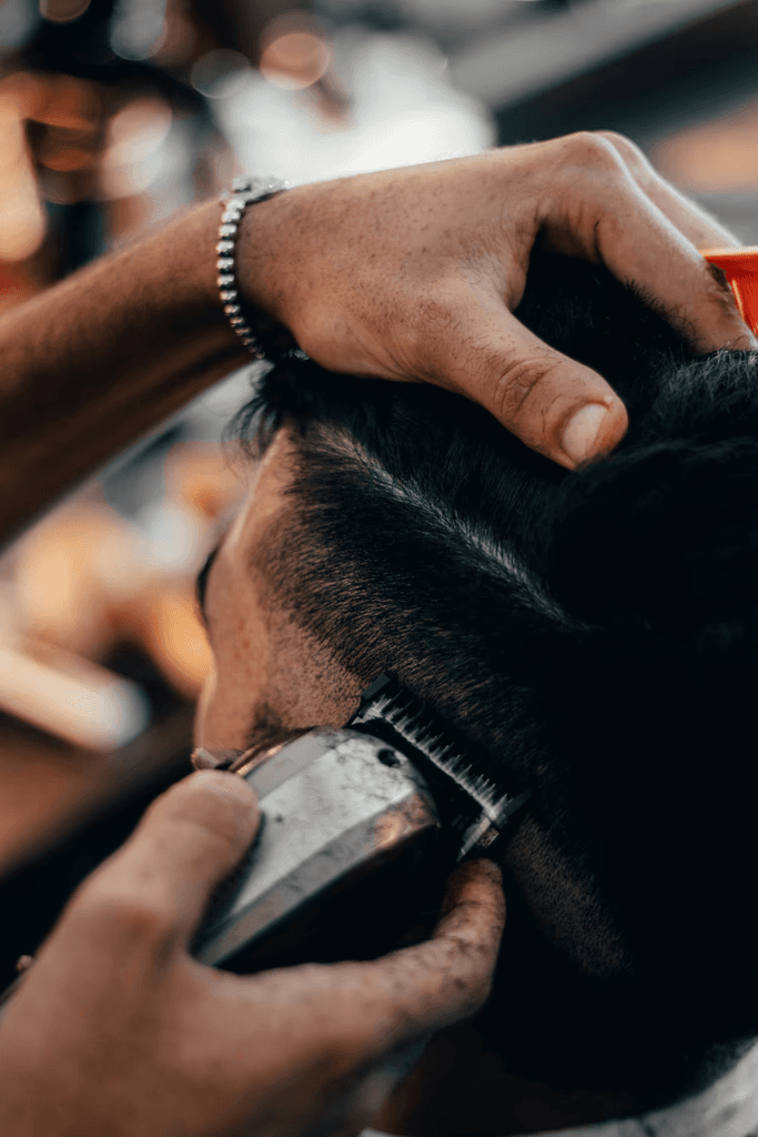 A barber cutting a client's hair