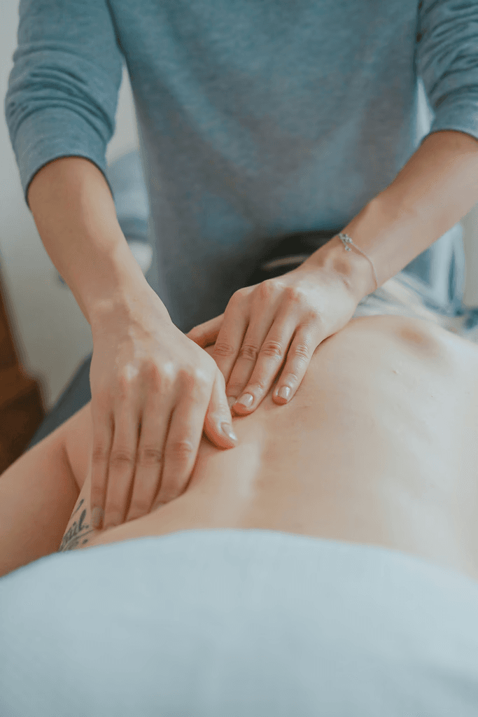 Hands performing a back massage